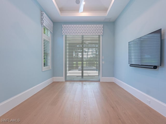 130 Burning Tree Dr, Naples, FL 34105 - empty room with a raised ceiling and wood finished floors