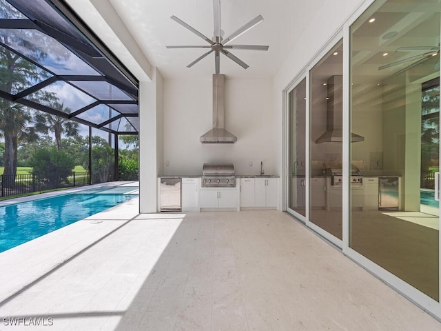 130 Burning Tree Dr, Naples, FL 34105 - view of pool featuring exterior kitchen, ceiling fan, a patio, and a lanai