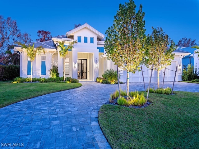 130 Burning Tree Dr, Naples, FL 34105 - view of front facade with curved driveway, a front lawn, and stucco siding