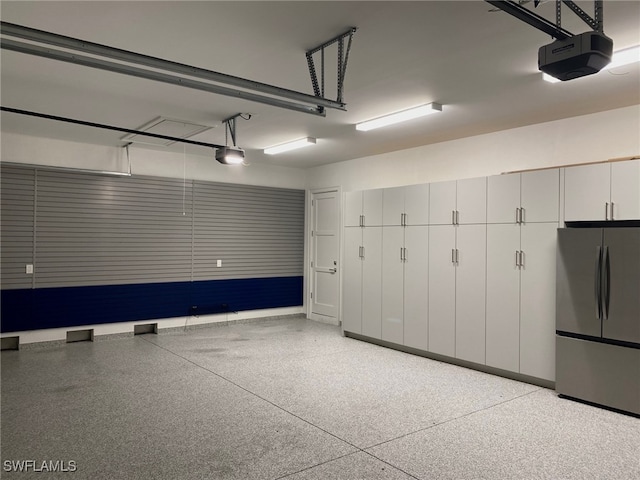 130 Burning Tree Dr, Naples, FL 34105 - garage featuring freestanding refrigerator and a garage door opener