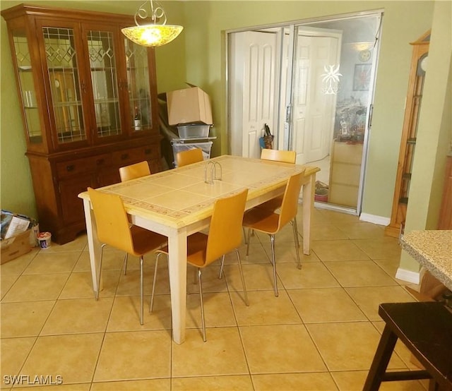 340 Inwood Ave S, Lehigh Acres, FL 33936 - dining room featuring light tile patterned flooring and baseboards