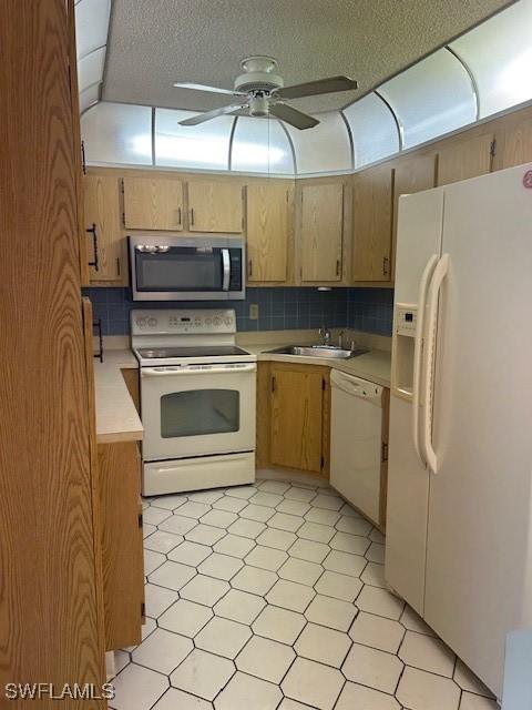 9950 Sailview Ct Unit 12, Fort Myers, FL 33905 - kitchen with white appliances, light countertops, light floors, ceiling fan, and decorative backsplash