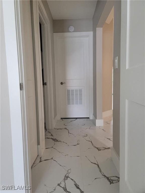 709 Landover Cir Unit 203, Naples, FL 34104 - hallway featuring marble tiled floors and baseboards