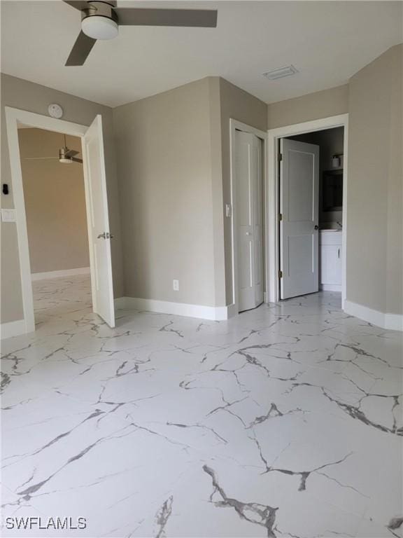 709 Landover Cir Unit 203, Naples, FL 34104 - unfurnished bedroom with light marble finish floors, a closet, and ceiling fan