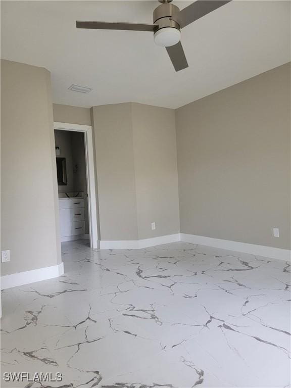 709 Landover Cir Unit 203, Naples, FL 34104 - unfurnished room with marble look tiles and ceiling fan