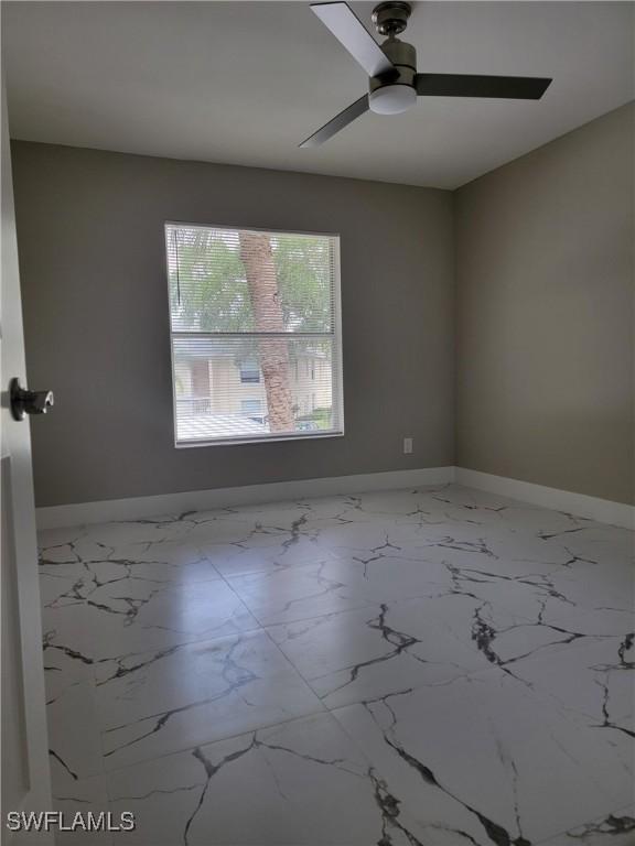 709 Landover Cir Unit 203, Naples, FL 34104 - empty room with a ceiling fan and baseboards