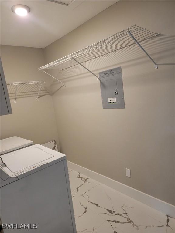 709 Landover Cir Unit 203, Naples, FL 34104 - laundry room with electric panel, washing machine and clothes dryer, and marble finish flooring