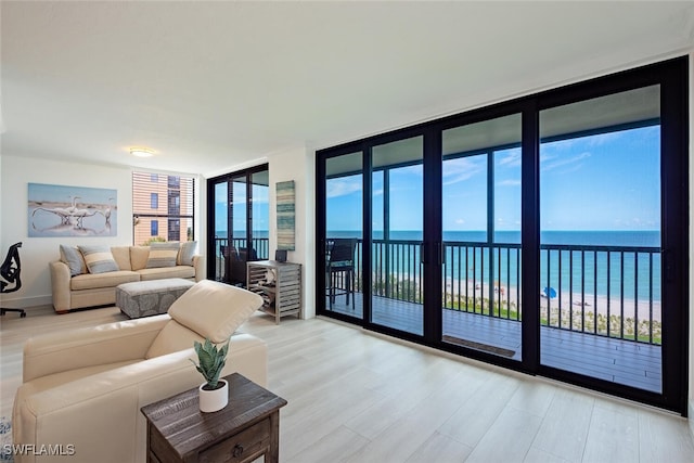9375 Gulf Shore Dr Unit 402, Naples, FL 34108 - living room with wood finished floors, view of water and beach, and floor to ceiling windows
