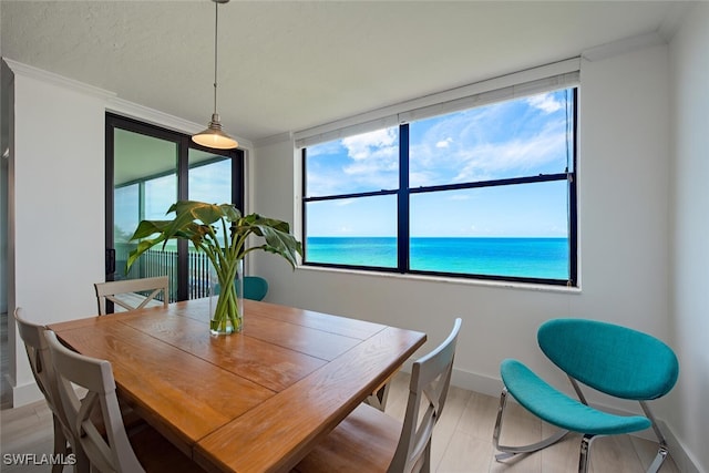 9375 Gulf Shore Dr Unit 402, Naples, FL 34108 - dining room featuring crown molding and a water view