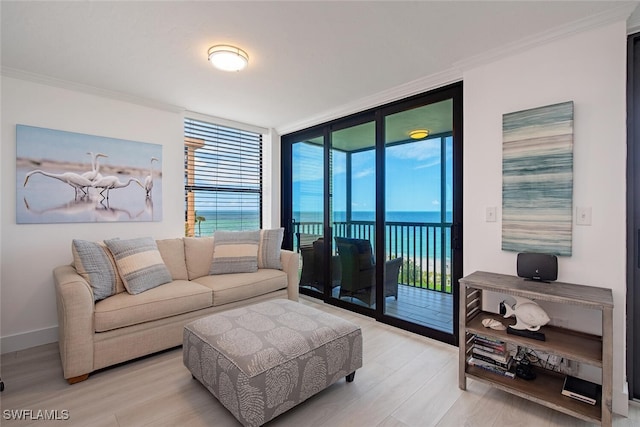 9375 Gulf Shore Dr Unit 402, Naples, FL 34108 - living area with a wall of windows, wood finished floors, crown molding, and a water view