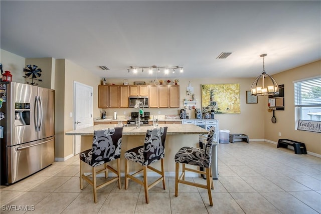1817 SW 3rd Ave, Cape Coral, FL 33991 - kitchen featuring appliances with stainless steel finishes, light tile patterned floors, a center island with sink, and a chandelier