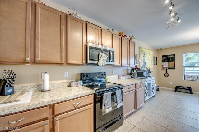 1817 SW 3rd Ave, Cape Coral, FL 33991 - kitchen featuring stainless steel microwave, black electric range, light tile patterned flooring, and heating unit