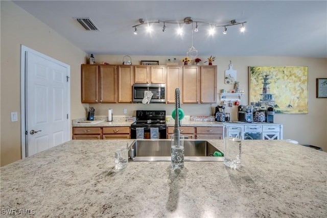 1817 SW 3rd Ave, Cape Coral, FL 33991 - kitchen featuring stainless steel microwave, black electric range oven, and light stone countertops