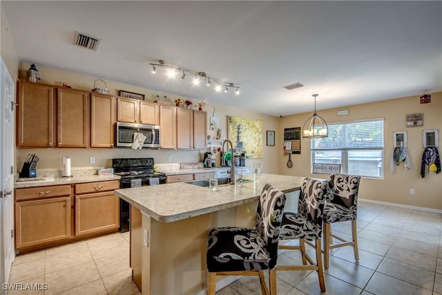 1817 SW 3rd Ave, Cape Coral, FL 33991 - kitchen with stainless steel microwave, black range with electric cooktop, light countertops, and light tile patterned flooring