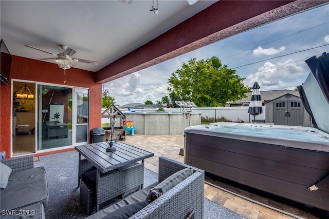 1817 SW 3rd Ave, Cape Coral, FL 33991 - view of patio featuring a hot tub, a ceiling fan, a storage unit, and an outdoor hangout area