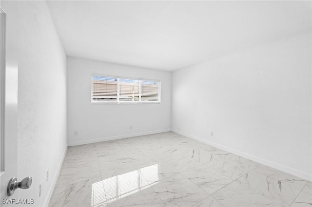 601 Periwinkle Way Unit D1, Sanibel, FL 33957 - unfurnished room with marble look tile flooring and baseboards