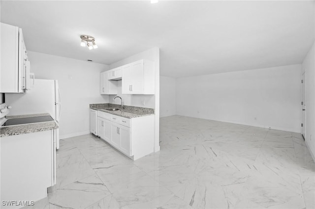 601 Periwinkle Way Unit D1, Sanibel, FL 33957 - kitchen featuring light marble finish floors, white cabinets, range, and open floor plan
