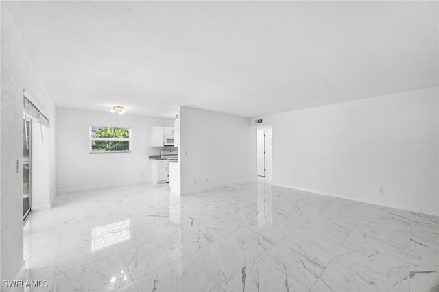 601 Periwinkle Way Unit D1, Sanibel, FL 33957 - unfurnished living room with light marble finish flooring and baseboards