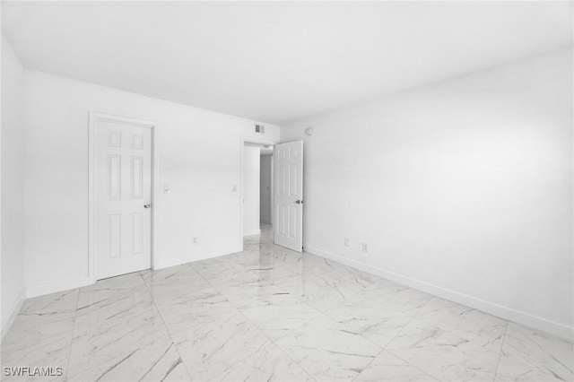 601 Periwinkle Way Unit D1, Sanibel, FL 33957 - empty room with light marble finish floors and baseboards