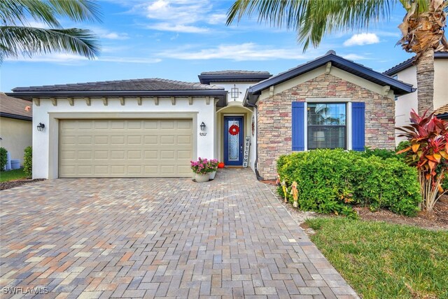 9207 Shadow Oak Ln, Naples, FL 34120 - ranch-style house with decorative driveway, an attached garage, and stucco siding