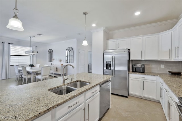 9207 Shadow Oak Ln, Naples, FL 34120 - kitchen with appliances with stainless steel finishes, ornamental molding, white cabinetry, tasteful backsplash, and light stone counters