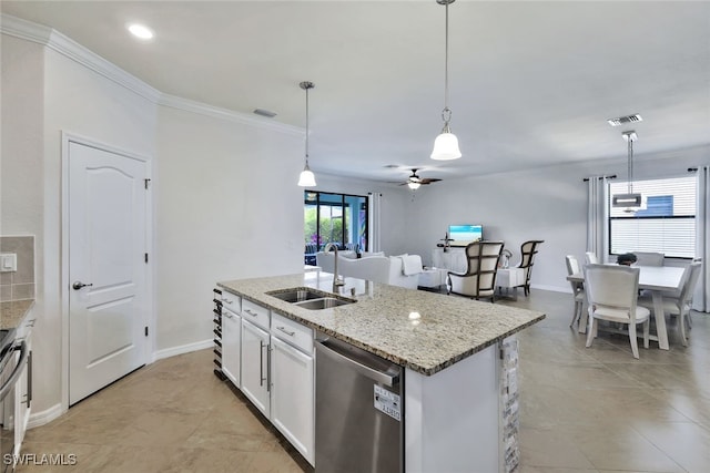 9207 Shadow Oak Ln, Naples, FL 34120 - kitchen featuring appliances with stainless steel finishes, ceiling fan, crown molding, an island with sink, and white cabinetry