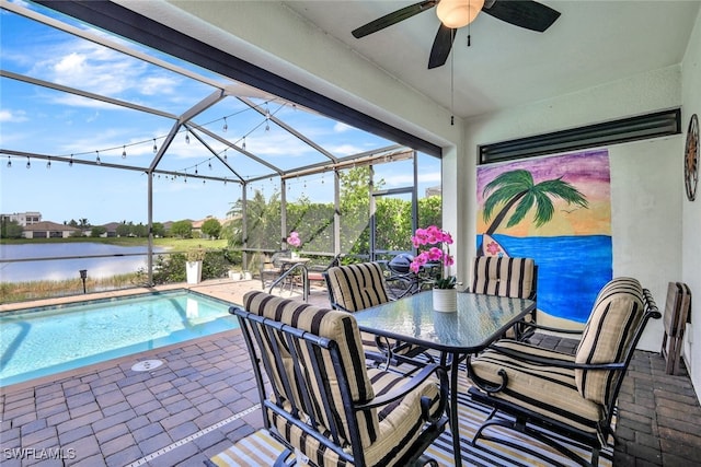 9207 Shadow Oak Ln, Naples, FL 34120 - swimming pool with a patio area, ceiling fan, a water view, outdoor dining space, and a lanai