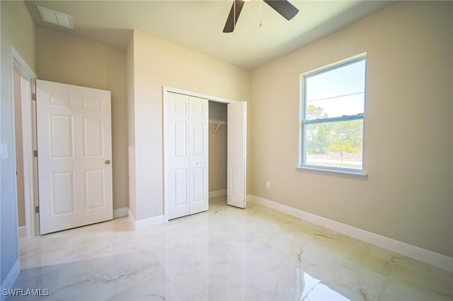 2817 43rd St W, Lehigh Acres, FL 33971 - unfurnished bedroom with marble finish floors, a closet, and a ceiling fan