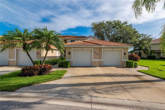 6325 Wilshire Pines Cir Unit 3, Naples, FL 34109 - mediterranean / spanish home with stucco siding, concrete driveway, a tiled roof, and a front yard
