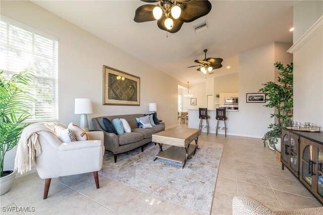 6325 Wilshire Pines Cir Unit 3, Naples, FL 34109 - living room featuring a ceiling fan, healthy amount of natural light, light tile patterned flooring, vaulted ceiling, and a chandelier