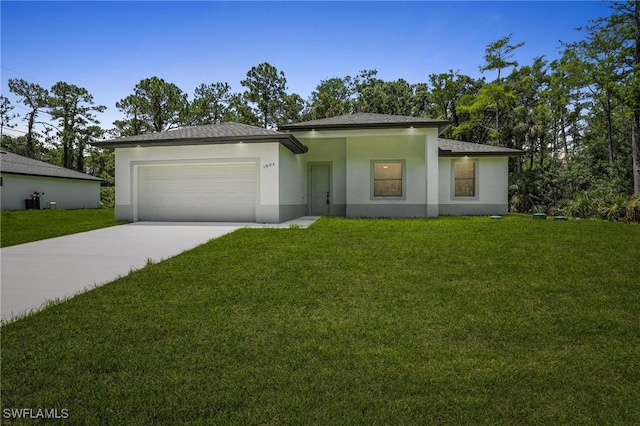 1002 E 17th St, Lehigh Acres, FL 33972 - prairie-style home with concrete driveway, an attached garage, a front yard, and stucco siding