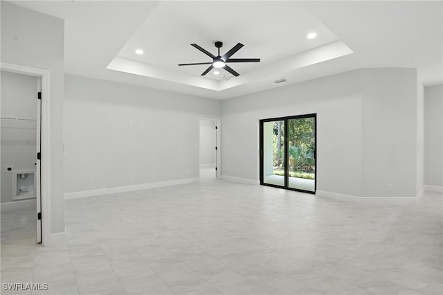 1002 E 17th St, Lehigh Acres, FL 33972 - spare room featuring ceiling fan, a raised ceiling, and recessed lighting