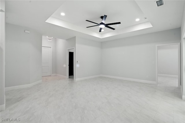 1002 E 17th St, Lehigh Acres, FL 33972 - spare room featuring a tray ceiling, ceiling fan, recessed lighting, and light floors