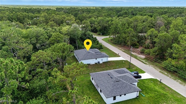 1002 E 17th St, Lehigh Acres, FL 33972 - view of subject property with a forest
