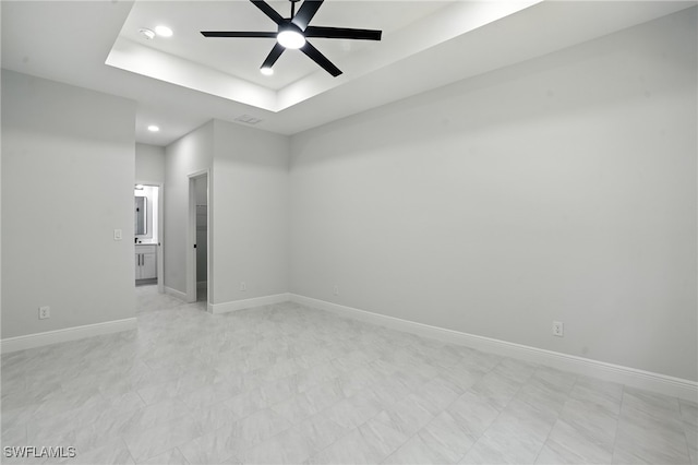 1002 E 17th St, Lehigh Acres, FL 33972 - unfurnished room with ceiling fan, recessed lighting, a raised ceiling, and light flooring