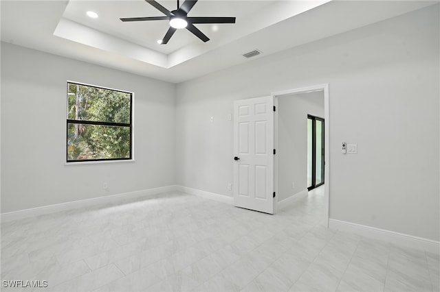 1002 E 17th St, Lehigh Acres, FL 33972 - empty room with ceiling fan, a tray ceiling, and recessed lighting