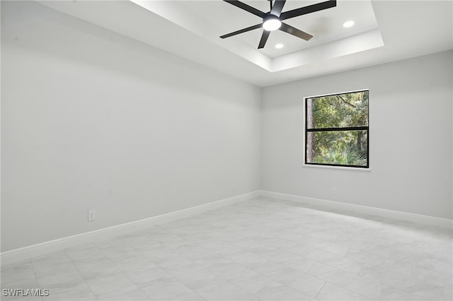 1002 E 17th St, Lehigh Acres, FL 33972 - unfurnished room with recessed lighting, a ceiling fan, and a raised ceiling