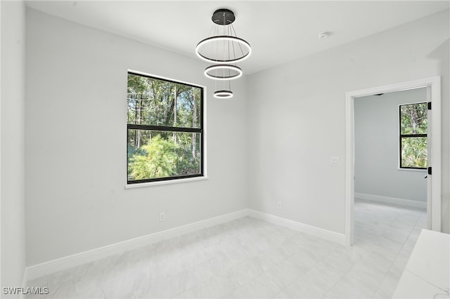 1002 E 17th St, Lehigh Acres, FL 33972 - spare room featuring plenty of natural light and a smoke detector