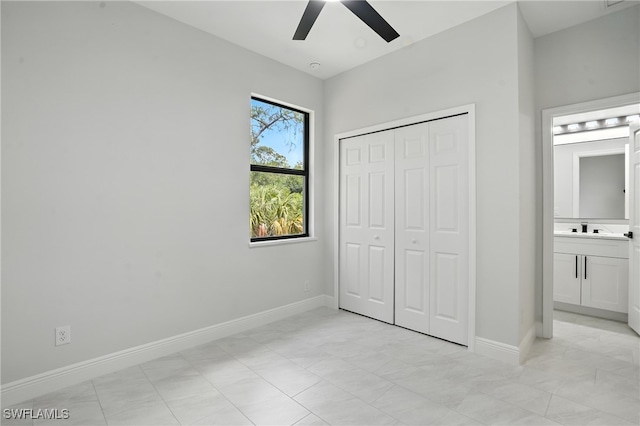 1002 E 17th St, Lehigh Acres, FL 33972 - unfurnished bedroom with a closet, ceiling fan, and ensuite bathroom