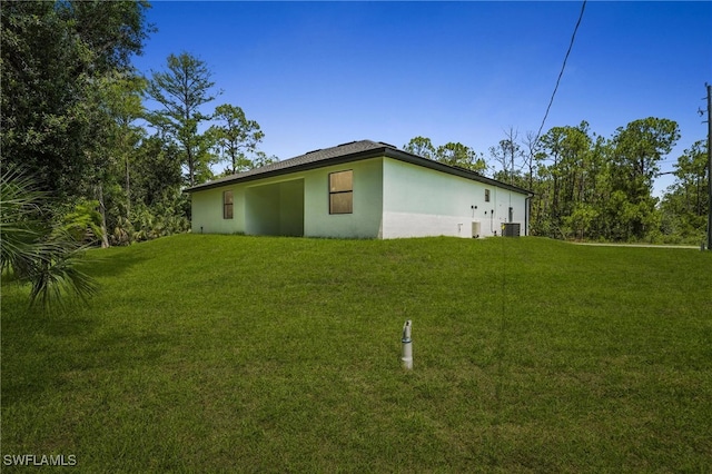 1002 E 17th St, Lehigh Acres, FL 33972 - view of side of property featuring stucco siding and a yard