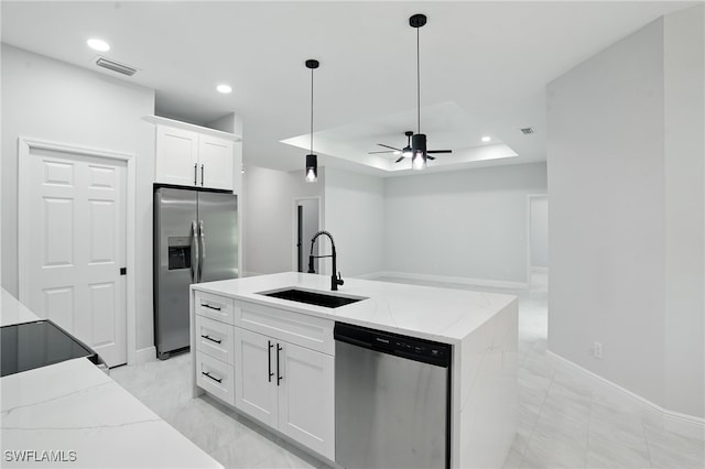 1002 E 17th St, Lehigh Acres, FL 33972 - kitchen featuring appliances with stainless steel finishes, white cabinets, light stone countertops, decorative light fixtures, and recessed lighting