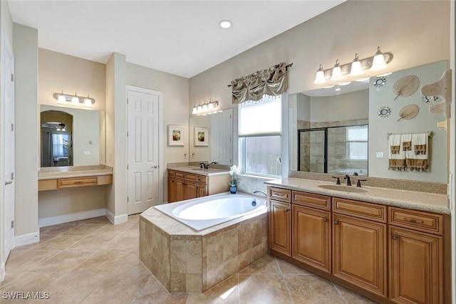9693 Cobalt Cove Cir, Naples, FL 34120 - bathroom with a stall shower, a bath, two vanities, and tile patterned floors