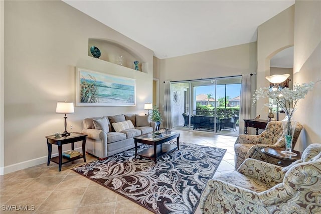 9693 Cobalt Cove Cir, Naples, FL 34120 - living room with a towering ceiling, light tile patterned floors, and built in shelves