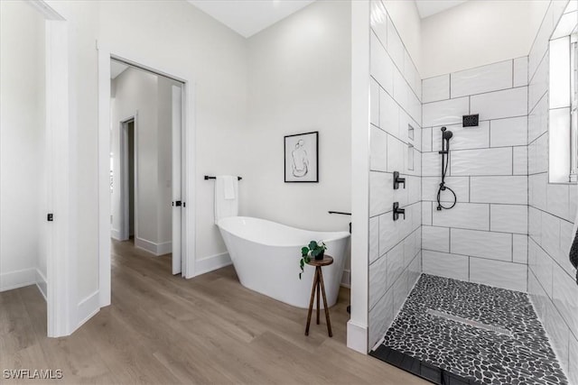 3548 Mondovi Ct, Punta Gorda, FL 33950 - full bathroom with tiled shower, a soaking tub, and wood finished floors