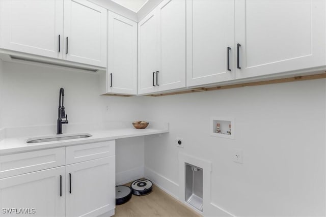 3548 Mondovi Ct, Punta Gorda, FL 33950 - laundry room featuring washer hookup, hookup for an electric dryer, cabinet space, and light wood-style floors