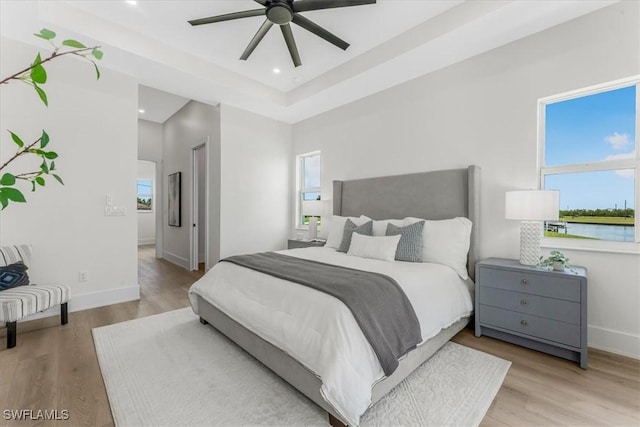 3548 Mondovi Ct, Punta Gorda, FL 33950 - bedroom with a tray ceiling, wood finished floors, recessed lighting, and ceiling fan
