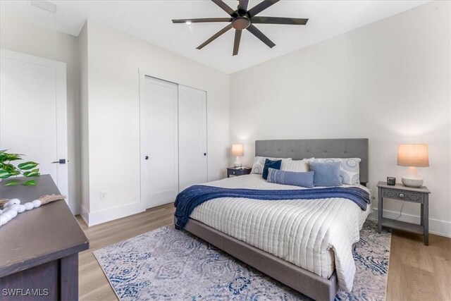 3548 Mondovi Ct, Punta Gorda, FL 33950 - bedroom with light wood-style floors, a closet, and a ceiling fan