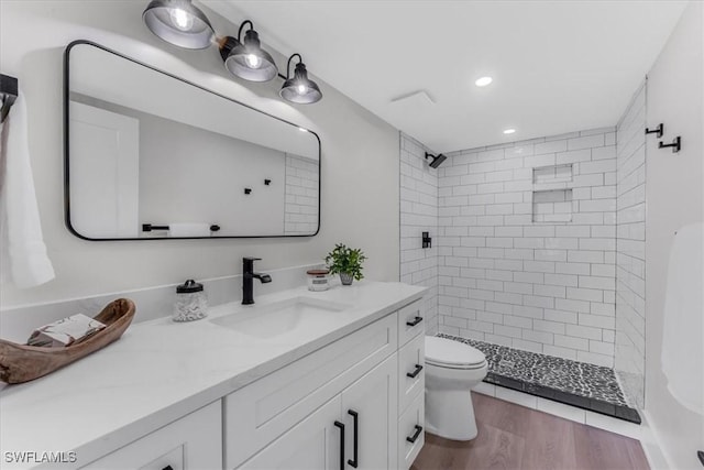 3548 Mondovi Ct, Punta Gorda, FL 33950 - bathroom featuring vanity, tiled shower, recessed lighting, and wood finished floors