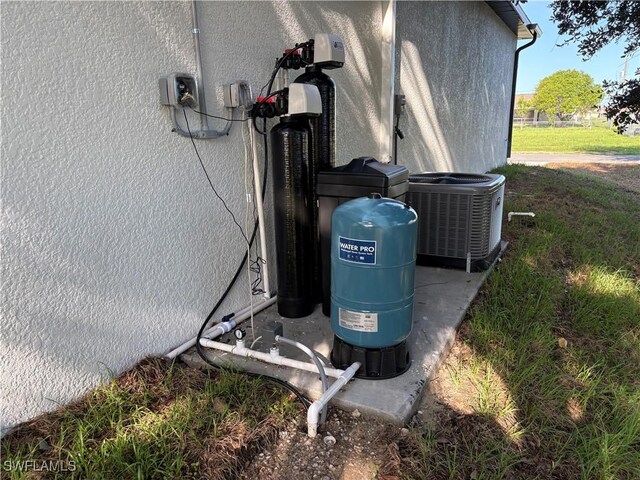 2035 NE 9th Ave, Cape Coral, FL 33909 - exterior view of stucco siding and a water softener