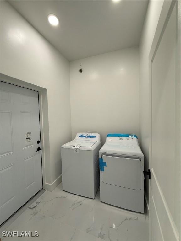 2035 NE 9th Ave, Cape Coral, FL 33909 - laundry room with washing machine and clothes dryer, light marble finish floors, and recessed lighting